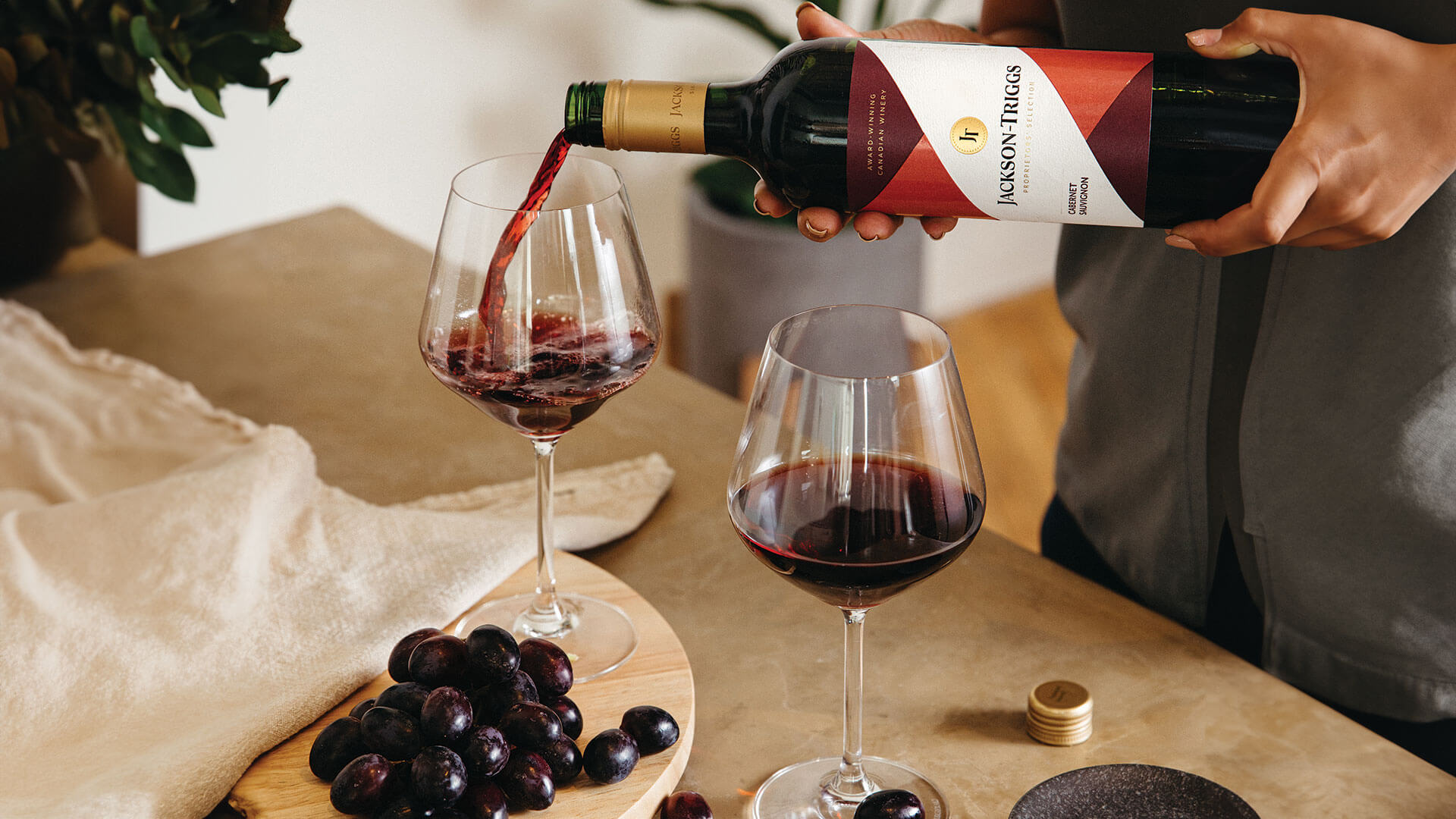 Pouring of Jackson-Triggs Cabernet Sauvignon paired with red grapes.