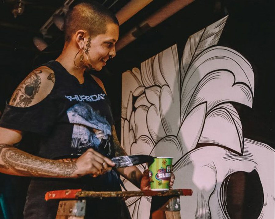 Artist painting a mural.
