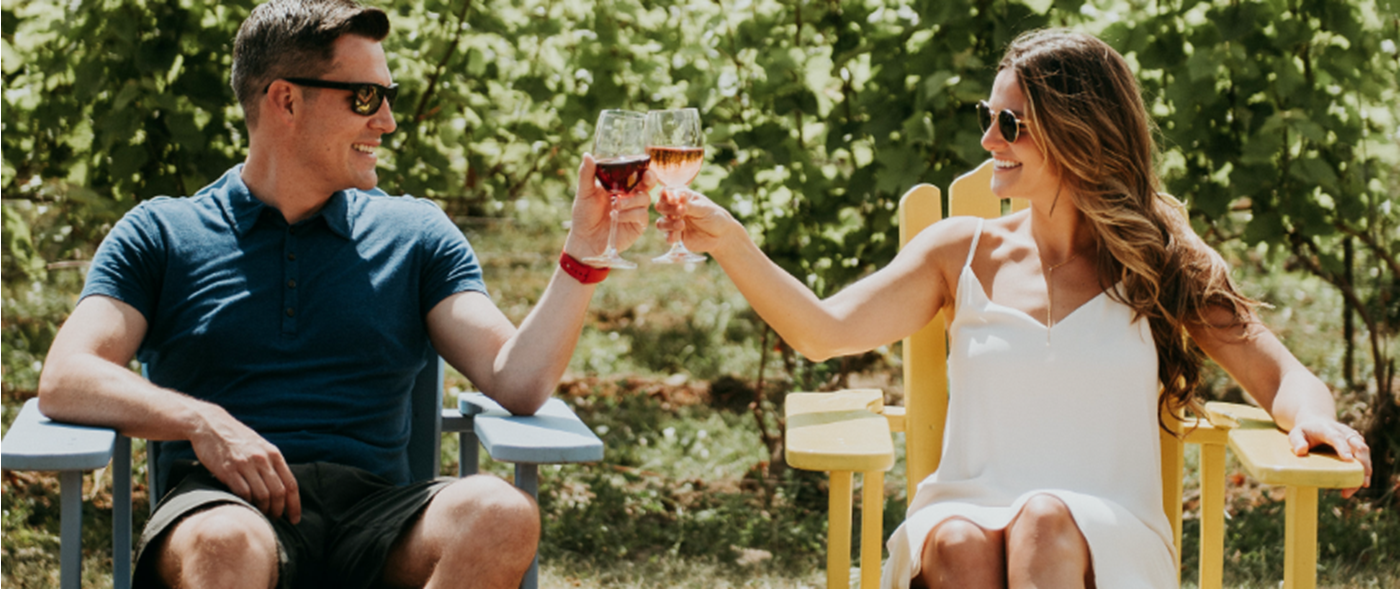 Sandbanks man and woman toasting a glass of wine
