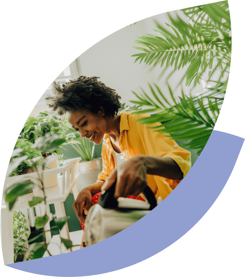 a person watering potted plants