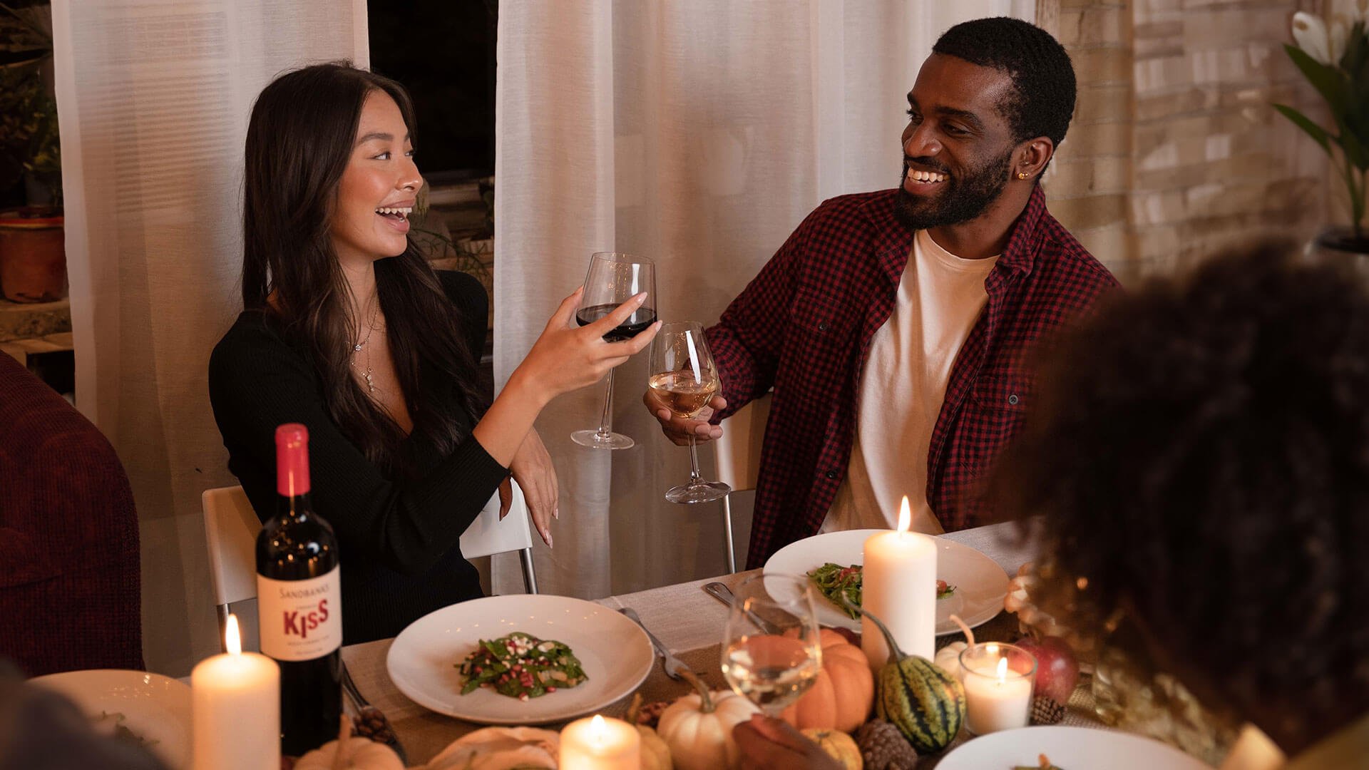 Toasting with a glass of Sandbanks French Kiss Merlot Cabernet VQA over Thanksgiving Dinner.