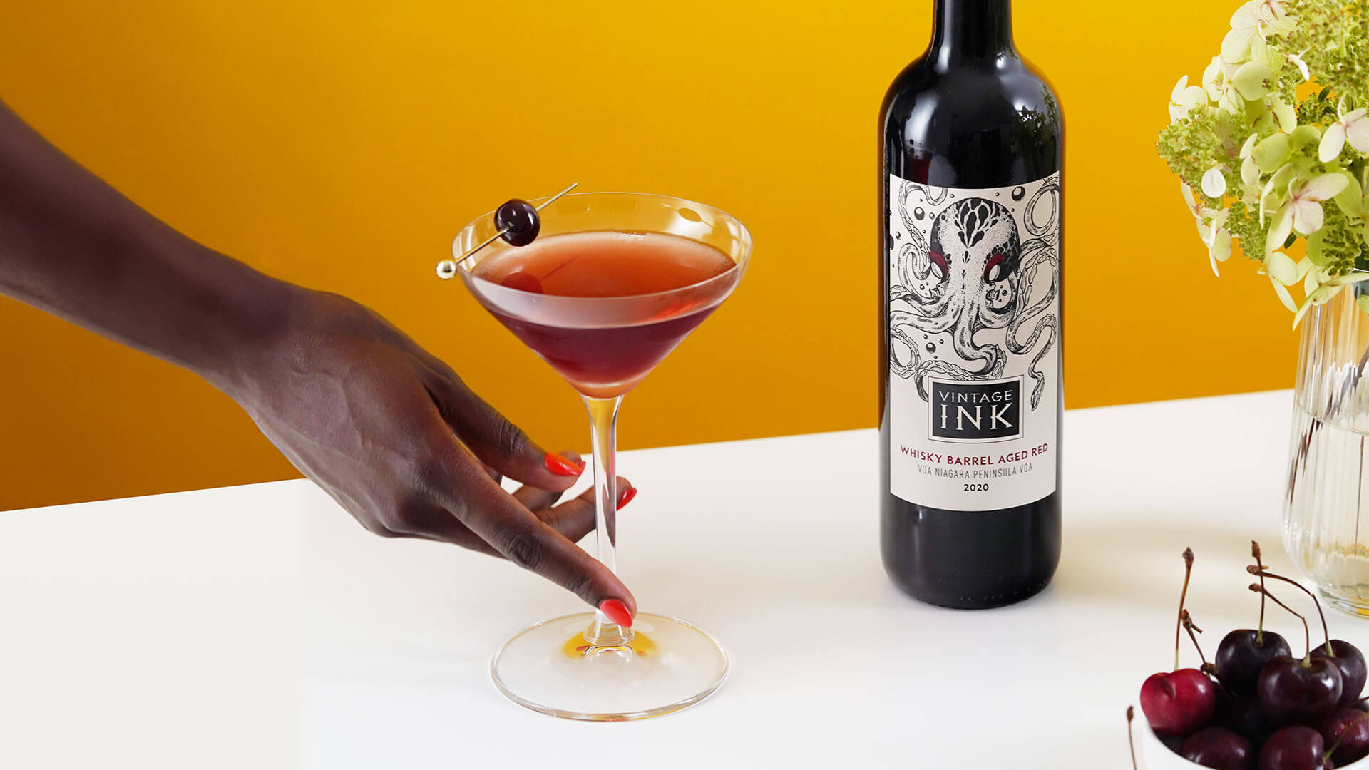 Wine and Cocktail lover showcasing the Vintage Ink Manhattan using Vintage Ink Whiskey Barrel Aged Red Wine.