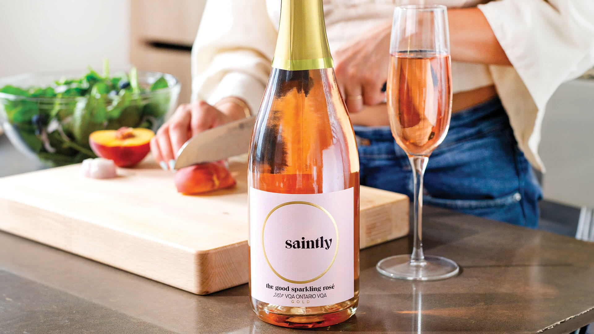 Wine lover preparing a salad to pair with Saintly the Good Sparkling Rose. 