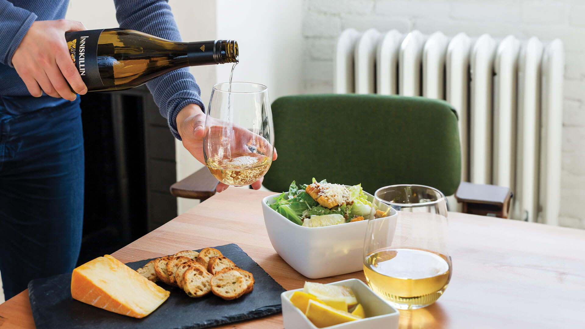Pouring of Inniskillin White Wine paired with crostini platter and Ceasar salad.