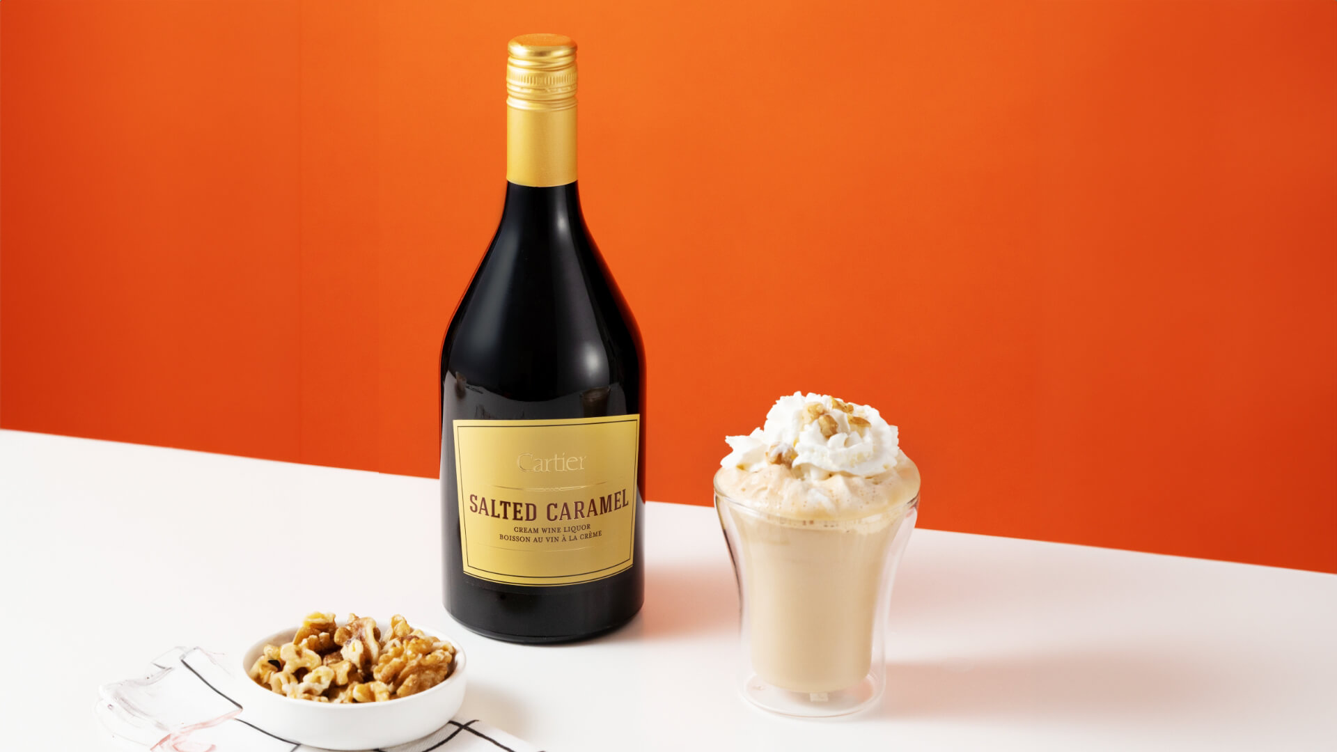 A bottle of Cartier Salted Caramel Irish Cream Wine Liquor with the Caramel Crunch Specialty Coffee.