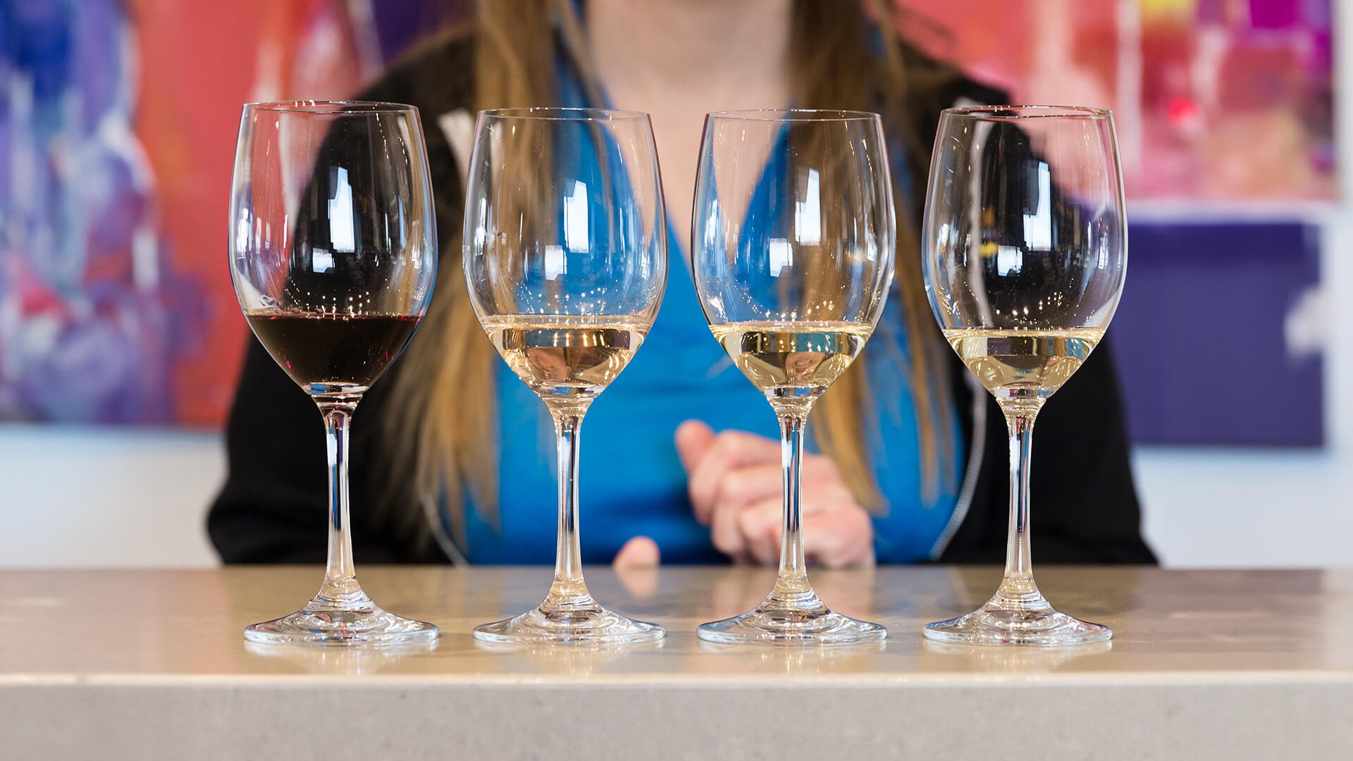 Wine glasses filled with different types of wine.